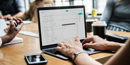 header image of the blog title "6 Time Tested Email Marketing Strategy For Your Business" with a background image of 5 persons in a room discussing